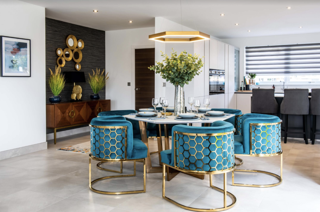 Design by Nykke, dining room table with teal and gold chairs